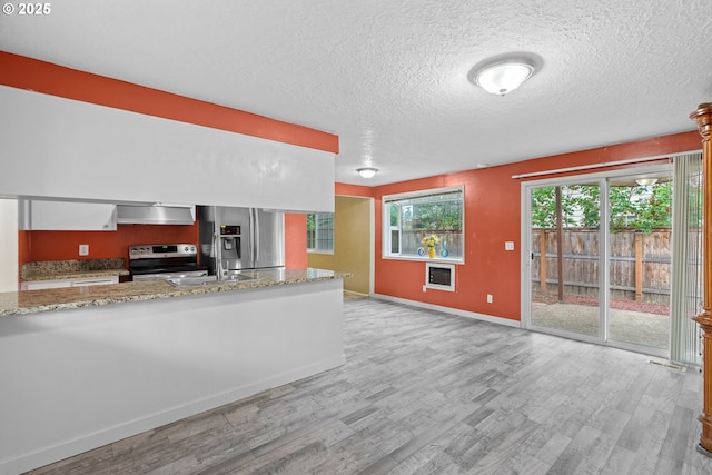 5715 SW 191st Ave, Beaverton, OR 97078 - kitchen with stainless steel appliances, light wood-style flooring, extractor fan, a textured ceiling, and light stone counters