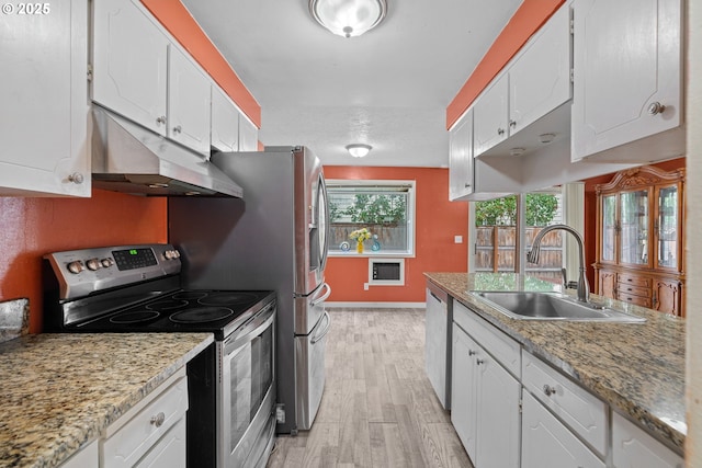 5715 SW 191st Ave, Beaverton, OR 97078 - kitchen featuring appliances with stainless steel finishes, under cabinet range hood, white cabinets, light wood-style floors, and light countertops