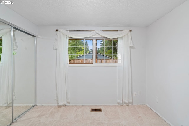 5715 SW 191st Ave, Beaverton, OR 97078 - unfurnished bedroom featuring a textured ceiling, carpet floors, and a closet