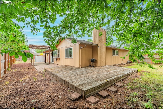 5715 SW 191st Ave, Beaverton, OR 97078 - rear view of property featuring a fenced backyard, a wooden deck, a pergola, and a chimney