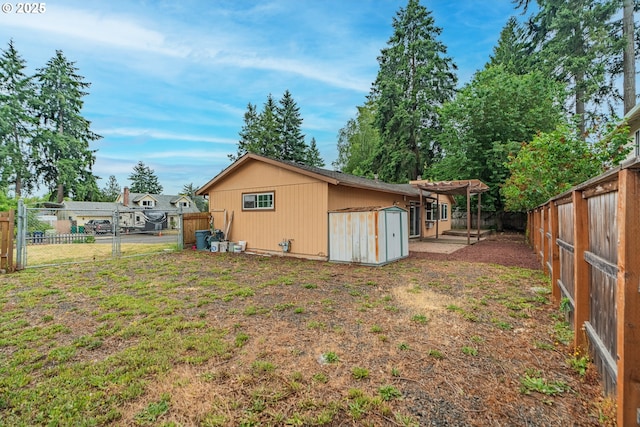 5715 SW 191st Ave, Beaverton, OR 97078 - back of property with a storage unit, a fenced backyard, and a pergola