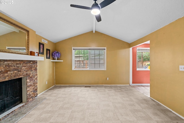 5715 SW 191st Ave, Beaverton, OR 97078 - unfurnished living room with a ceiling fan, a stone fireplace, healthy amount of natural light, and carpet flooring