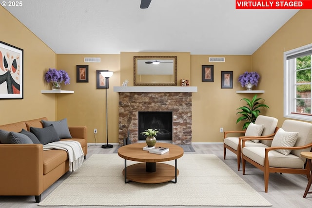 5715 SW 191st Ave, Beaverton, OR 97078 - living room with vaulted ceiling, wood finished floors, a fireplace with flush hearth, and a ceiling fan