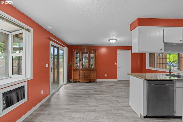 5715 SW 191st Ave, Beaverton, OR 97078 - kitchen with stainless steel dishwasher, light wood-style floors, white cabinets, a textured ceiling, and stone countertops
