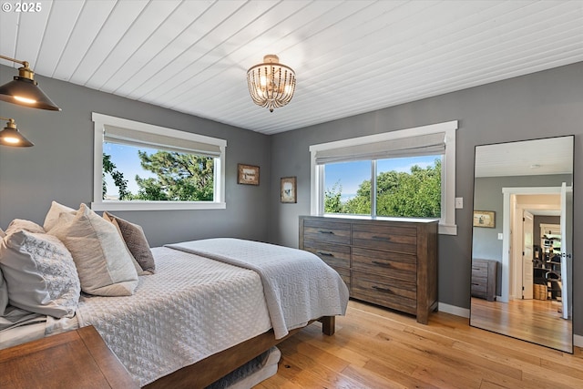 99 Walnut St, La Grande, OR 97850 - bedroom featuring multiple windows, a chandelier, and light wood-style floors