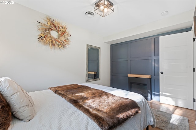 99 Walnut St, La Grande, OR 97850 - bedroom featuring wood finished floors and a glass covered fireplace