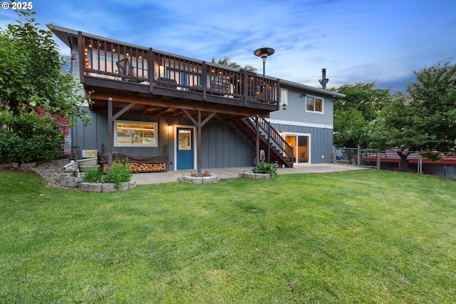 99 Walnut St, La Grande, OR 97850 - back of property featuring stairway, a deck, board and batten siding, and a patio area