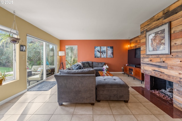 601 N Tomahawk Island Dr, Portland, OR 97217 - living room with wooden walls, an accent wall, baseboards, and light tile patterned flooring