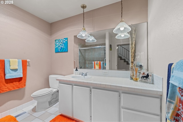 601 N Tomahawk Island Dr, Portland, OR 97217 - bathroom with vanity, a stall shower, tile patterned floors, toilet, and visible vents