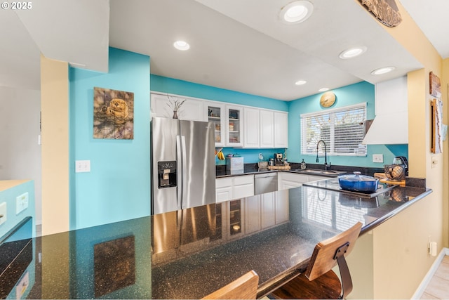 601 N Tomahawk Island Dr, Portland, OR 97217 - kitchen featuring glass insert cabinets, white cabinets, a sink, appliances with stainless steel finishes, and recessed lighting