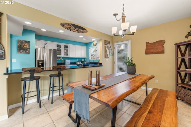 601 N Tomahawk Island Dr, Portland, OR 97217 - dining area featuring recessed lighting, light tile patterned floors, a notable chandelier, and baseboards