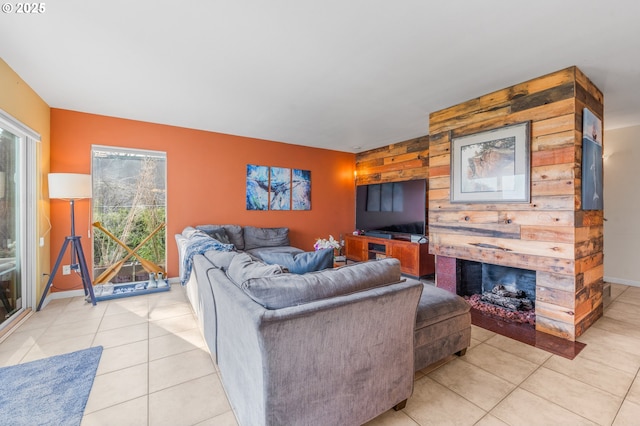 601 N Tomahawk Island Dr, Portland, OR 97217 - living room with baseboards, a fireplace, light tile patterned floors, wood walls, and an accent wall