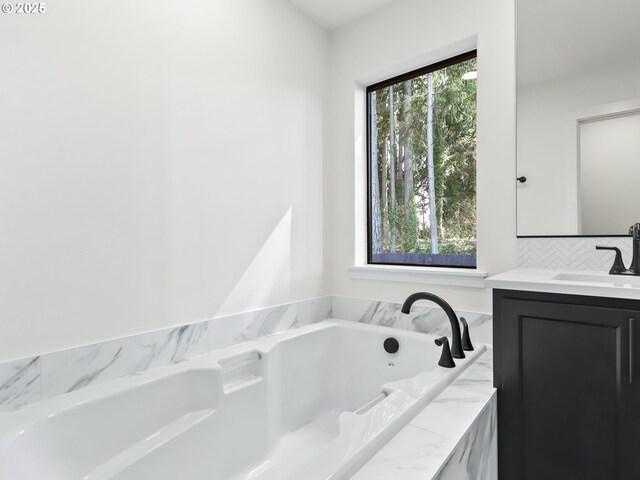full bathroom featuring tasteful backsplash, a garden tub, and vanity
