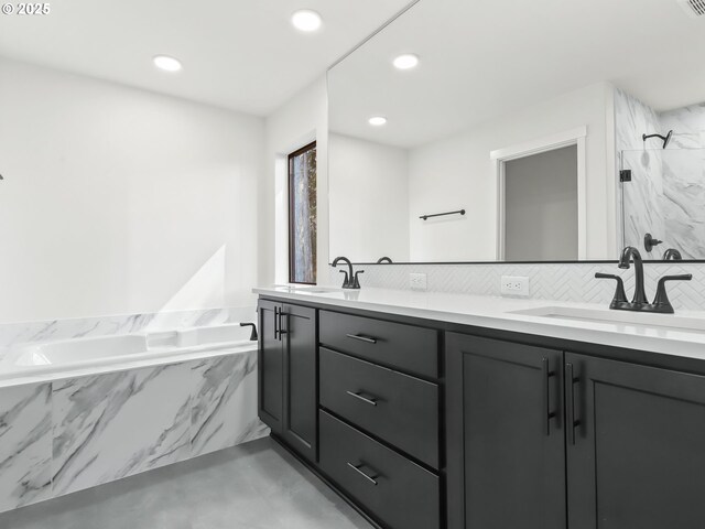 bathroom featuring a sink, a marble finish shower, backsplash, and double vanity