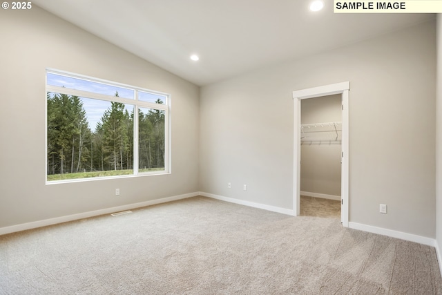 kitchen featuring white cabinets, appliances with stainless steel finishes, a peninsula, light countertops, and a sink