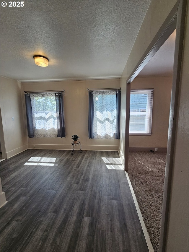 1760 W Broadway, Eugene, OR 97402 - unfurnished room with a textured ceiling, plenty of natural light, and dark wood-style flooring