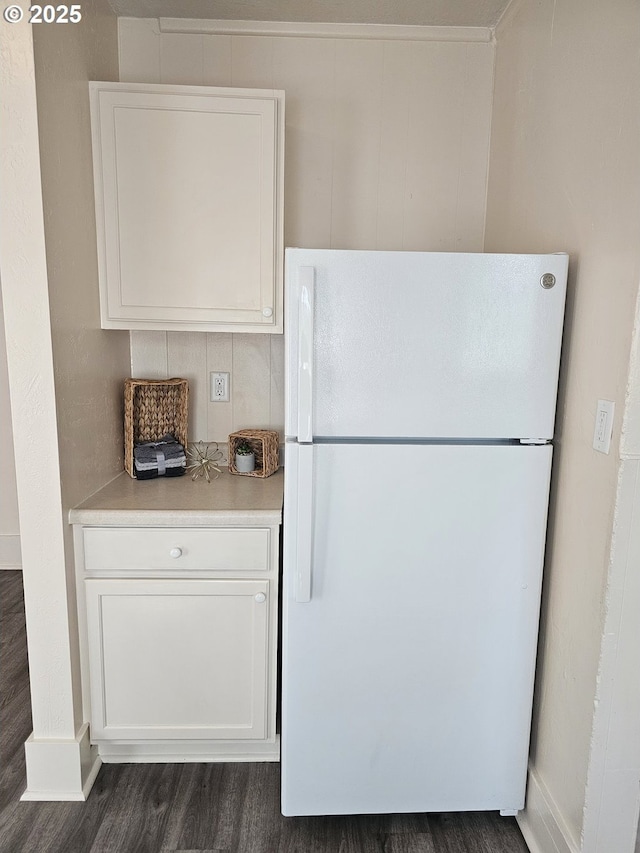 1760 W Broadway, Eugene, OR 97402 - kitchen with freestanding refrigerator, dark wood-style floors, white cabinetry, and light countertops