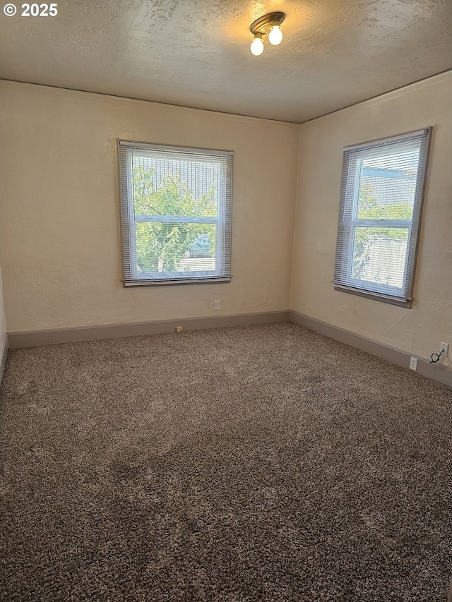 1760 W Broadway, Eugene, OR 97402 - spare room featuring plenty of natural light, carpet floors, and a textured ceiling