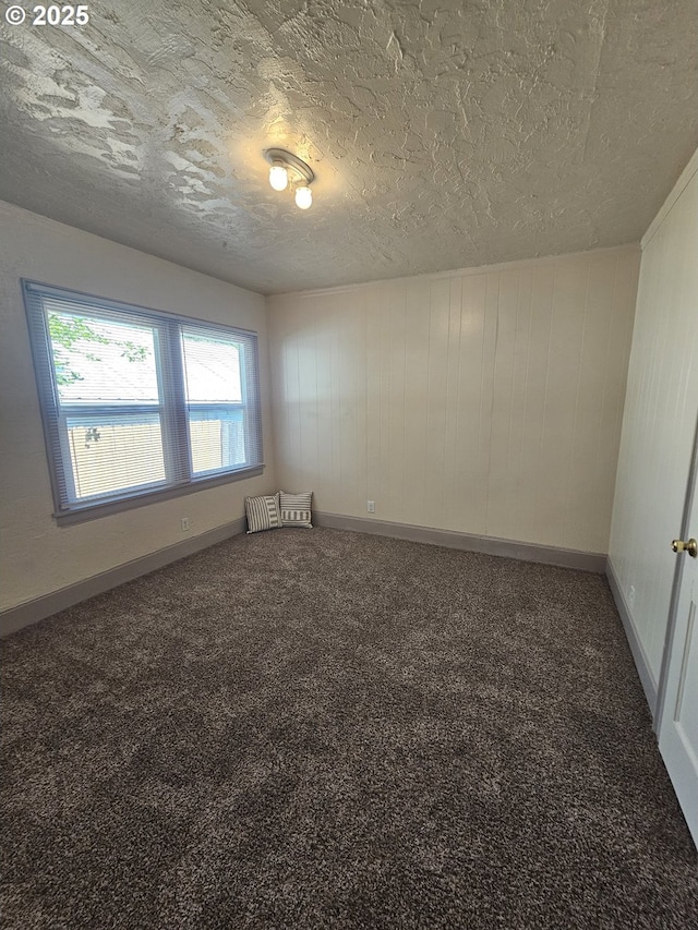 1760 W Broadway, Eugene, OR 97402 - carpeted spare room with a textured ceiling and wood walls