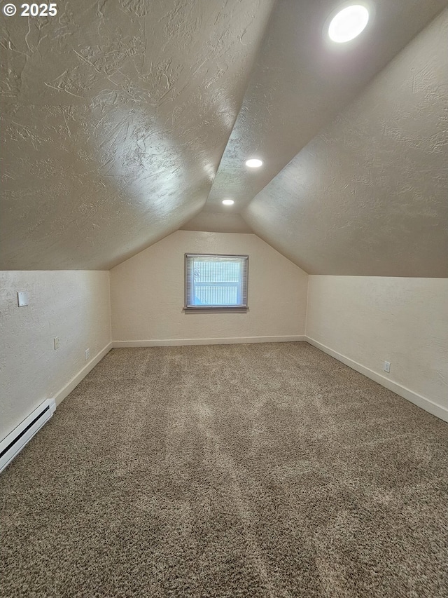 1760 W Broadway, Eugene, OR 97402 - additional living space featuring a textured ceiling, a baseboard heating unit, vaulted ceiling, and carpet flooring
