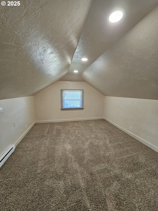 1760 W Broadway, Eugene, OR 97402 - additional living space with a textured ceiling, vaulted ceiling, carpet floors, and a baseboard radiator