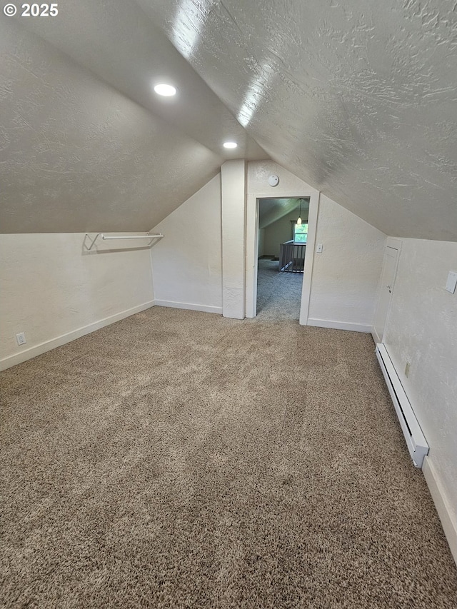 1760 W Broadway, Eugene, OR 97402 - additional living space with baseboard heating, a textured ceiling, carpet flooring, and lofted ceiling