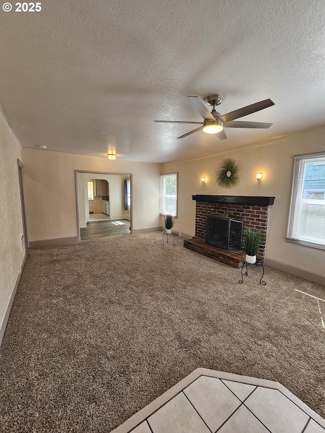 1760 W Broadway, Eugene, OR 97402 - unfurnished living room with a fireplace, ceiling fan, a textured ceiling, and carpet flooring