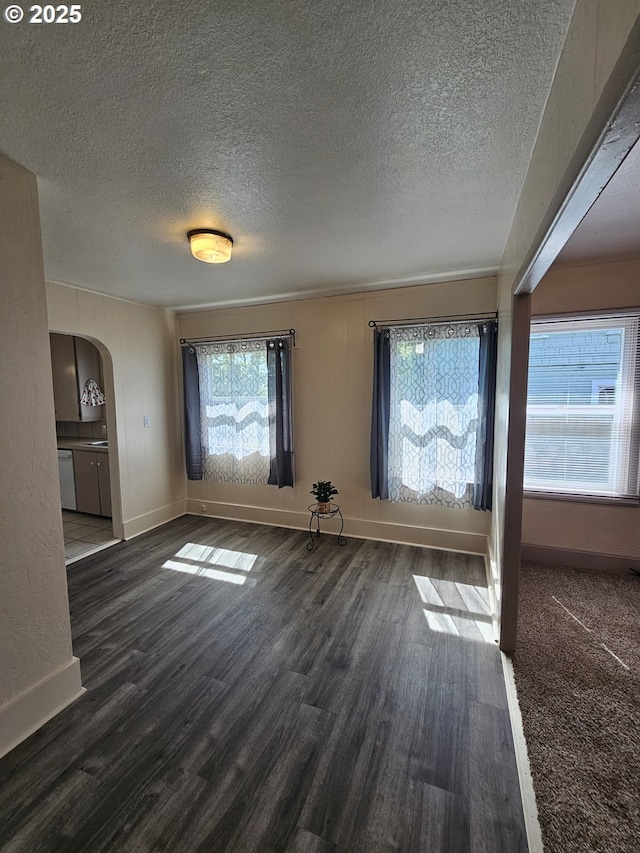 1760 W Broadway, Eugene, OR 97402 - unfurnished living room featuring arched walkways, a textured ceiling, and wood finished floors