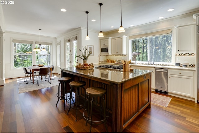 4054 Canal Woods Ct, Lake Oswego, OR 97034 - kitchen featuring tasteful backsplash, a wealth of natural light, ornamental molding, and stainless steel appliances