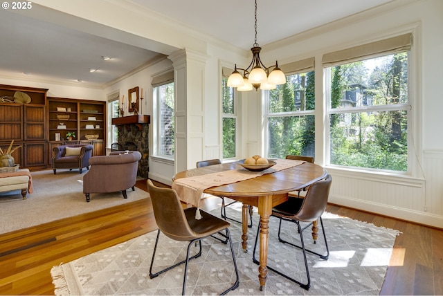 4054 Canal Woods Ct, Lake Oswego, OR 97034 - dining area featuring a decorative wall, wood finished floors, a healthy amount of sunlight, and crown molding