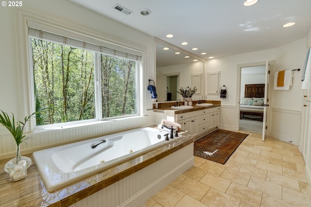 4054 Canal Woods Ct, Lake Oswego, OR 97034 - full bathroom featuring a wainscoted wall, ensuite bathroom, visible vents, a jetted tub, and vanity