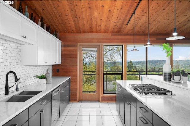 kitchen featuring light tile patterned floors, dishwasher, wooden ceiling, gas stovetop, and a sink