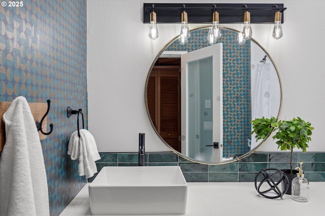 full bath with tasteful backsplash and a sink