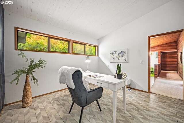 home office with lofted ceiling and baseboards