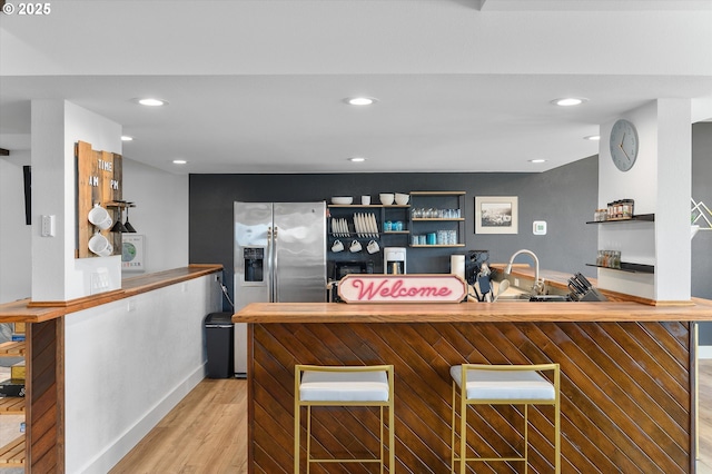 kitchen with open shelves, butcher block countertops, light wood-style flooring, and recessed lighting