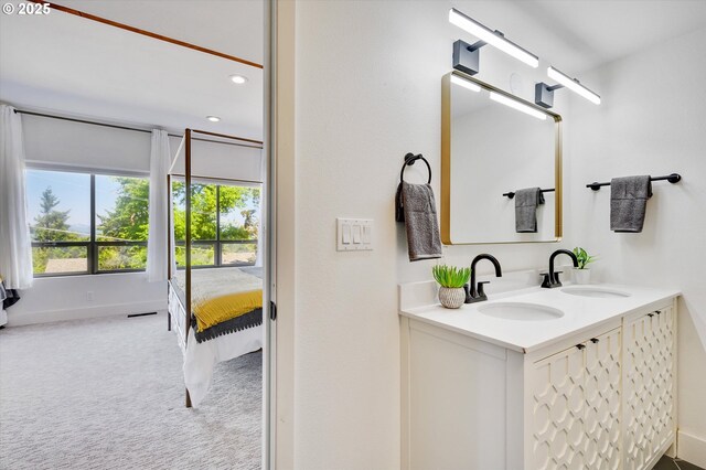 bathroom with recessed lighting, visible vents, a sink, and ensuite bath