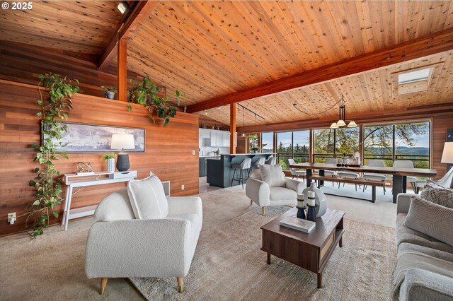 living room featuring a healthy amount of sunlight, wood walls, and carpet