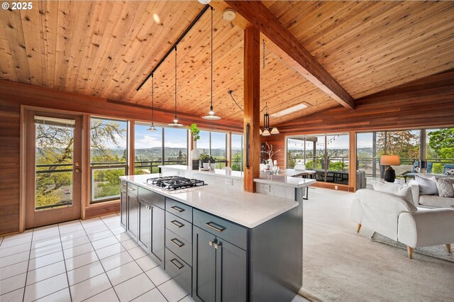 kitchen featuring open floor plan, wooden ceiling, gas cooktop, and light tile patterned flooring