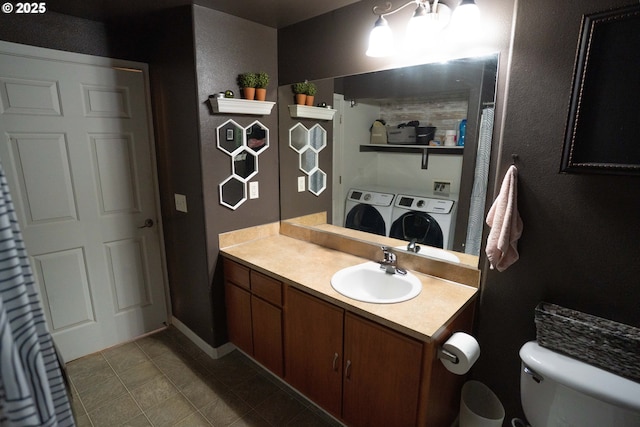 bathroom featuring vanity, tile patterned floors, washer and clothes dryer, and toilet