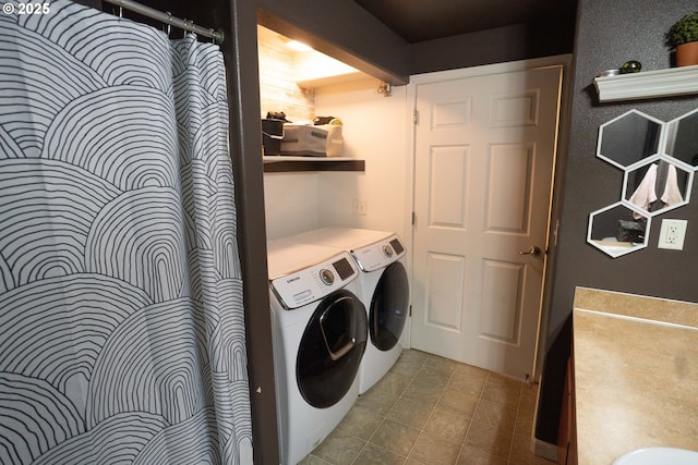 laundry room with tile patterned floors and washing machine and clothes dryer