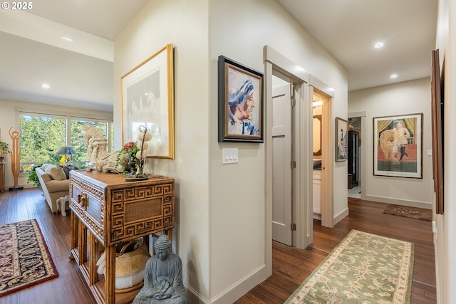 hallway with baseboards, dark wood-style flooring, and recessed lighting