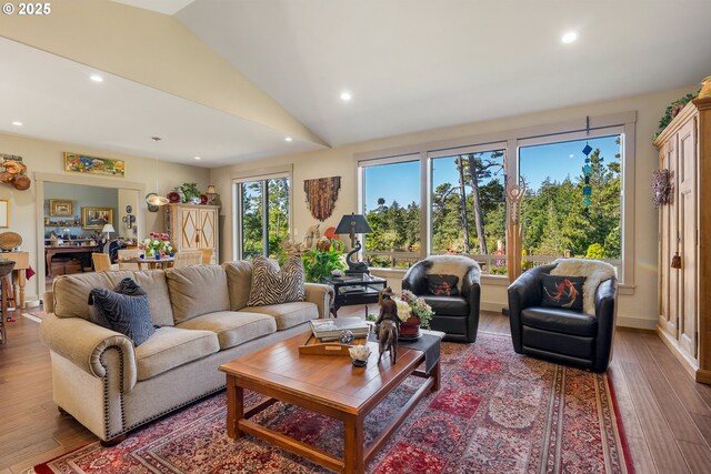 living area featuring wood finished floors, lofted ceiling, and recessed lighting