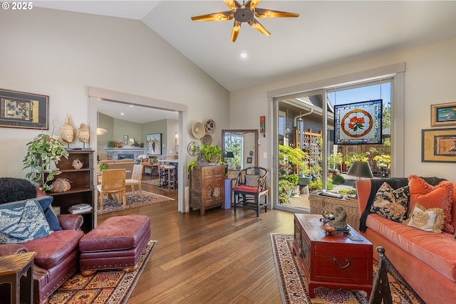 living area featuring a ceiling fan, recessed lighting, high vaulted ceiling, and wood finished floors