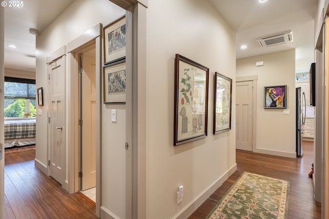 hallway featuring recessed lighting, baseboards, visible vents, and wood finished floors