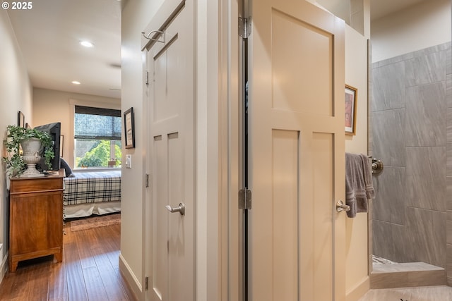 hall with wood-type flooring and recessed lighting