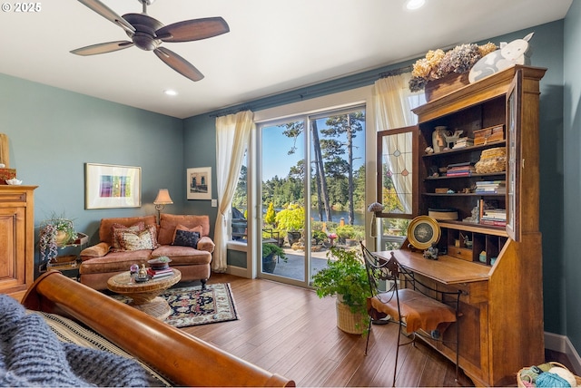 living area with ceiling fan, recessed lighting, and wood finished floors