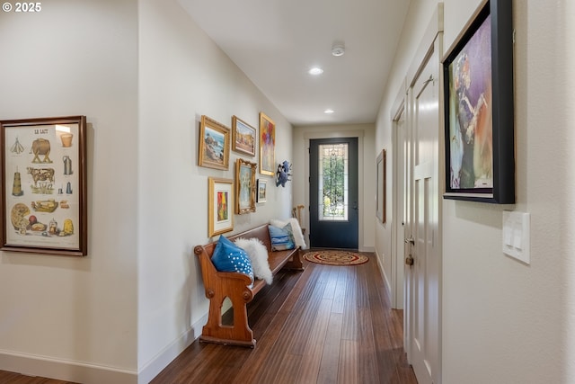 doorway featuring baseboards, dark wood-style floors, and recessed lighting