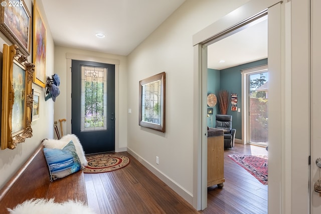 doorway to outside with dark wood-style flooring, baseboards, and recessed lighting