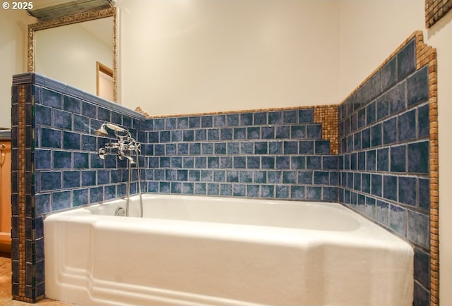 bathroom featuring tile walls, a bath, and a wainscoted wall