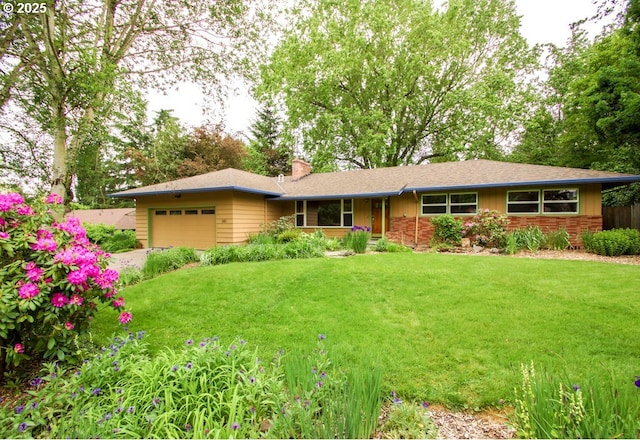 view of front of property with a garage, a front yard, a chimney, and driveway